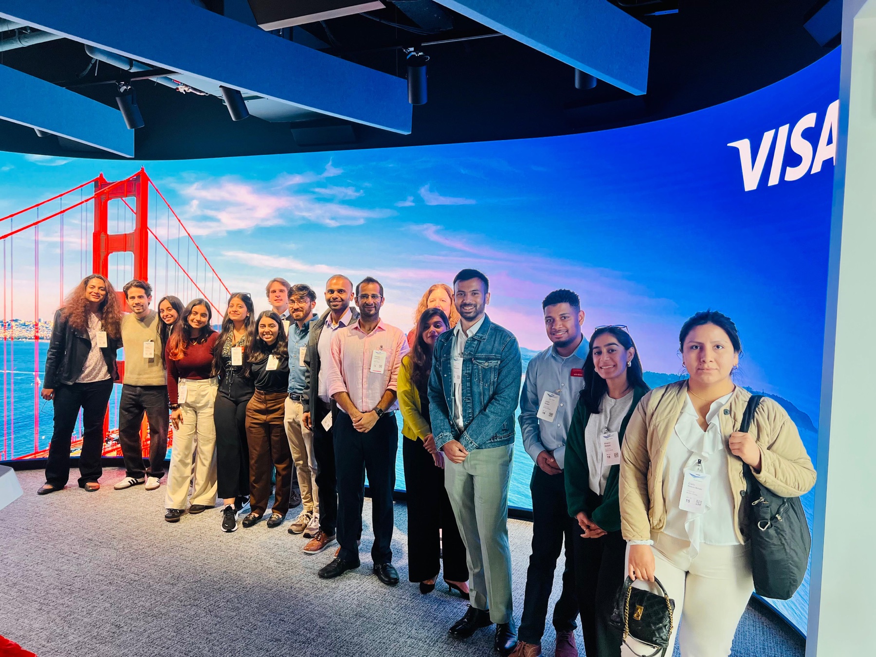 Kunal with the Tepper group in front of a Golden Gate Bridge display at Visa